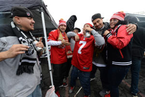 Fans of both the 49ers and the Raiders party together in the parking lot prior to the game between the Oakland Raiders and the San Francisco 49ers at O.co Coliseum in Oakland, Calif., on Sunday, Dec. 7, 2014. (Dan Honda/Bay Area News Group)